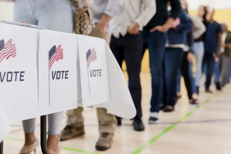 Voters standing in line, waiting to vote.